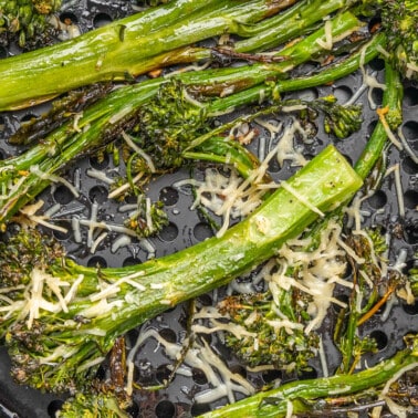 Close up overhead v view of broccolini in an air fryer.