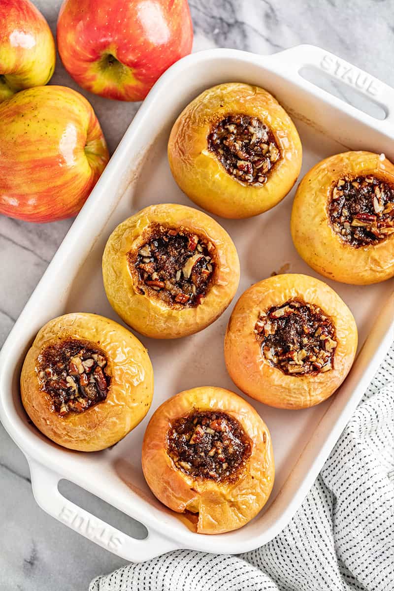 Overhead view of a tray filled with baked apples.