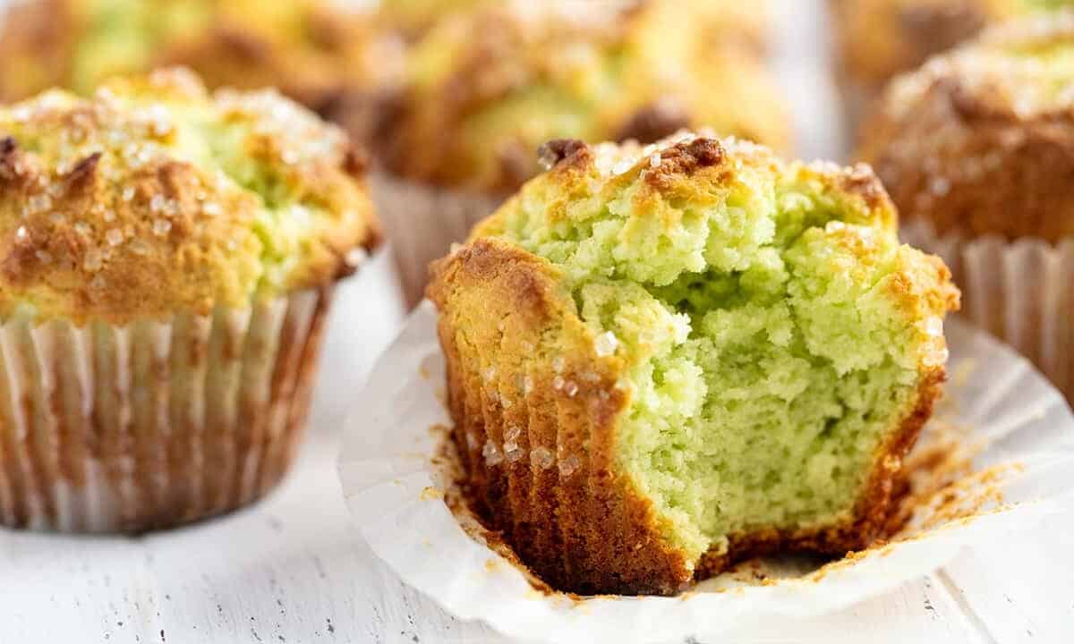 Close up of Pistachio Muffins one with a big bite out of it