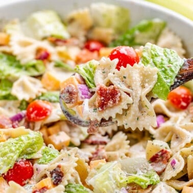 Close up view of BLT pasta salad in a serving bowl.