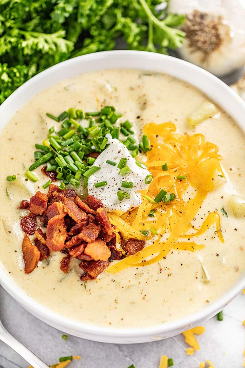 Creamy potato soup served into a white bowl.