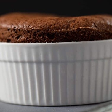 Perfectly fluffy Soufflé in a white ramekin.