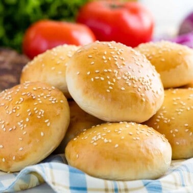 Stack of hamburger buns on a cloth.