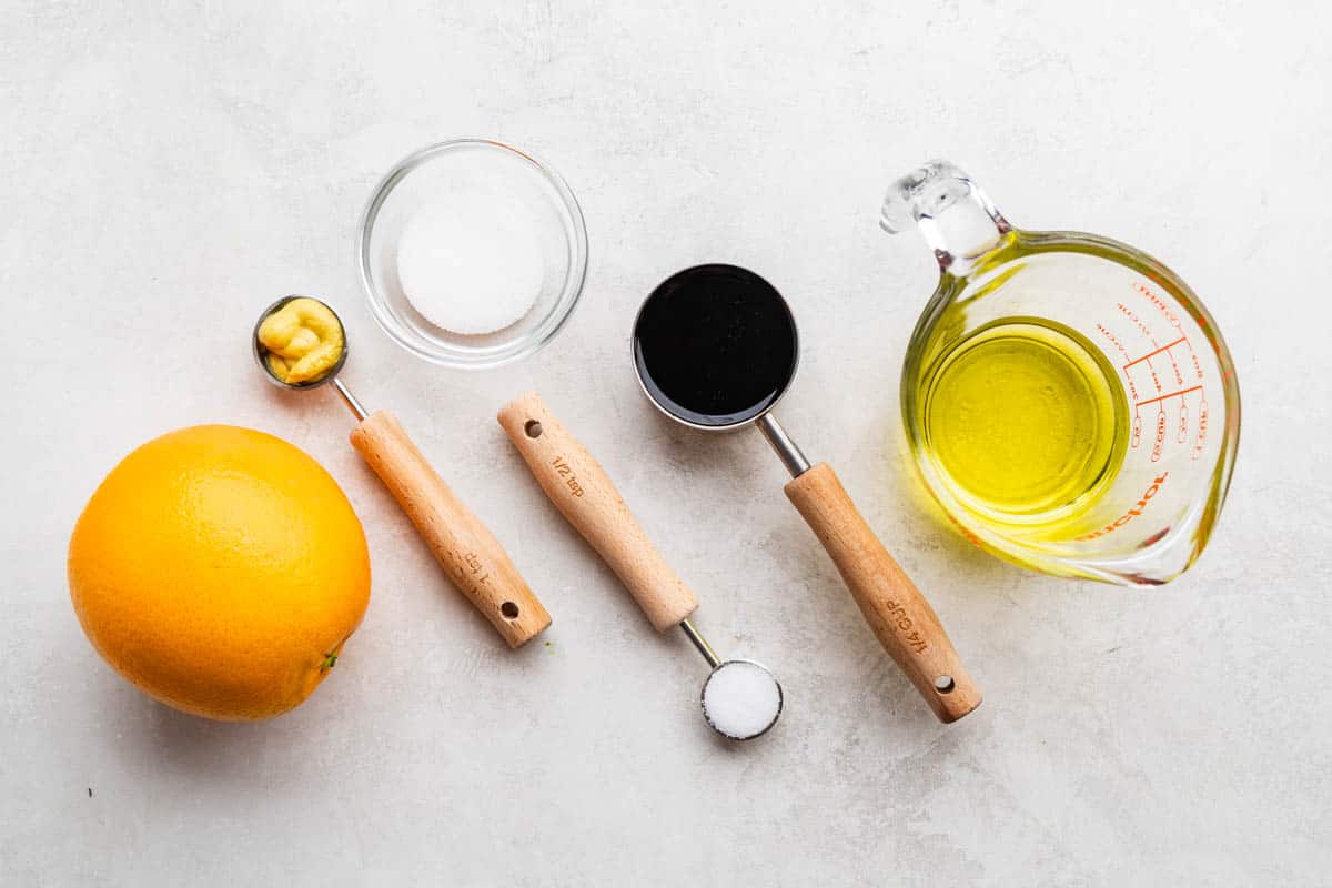 An overhead view of the ingredients needed to make our simple orange balsamic vinaigrette. 