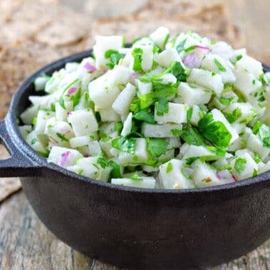 Small cast iron bowl filled with jicama salsa