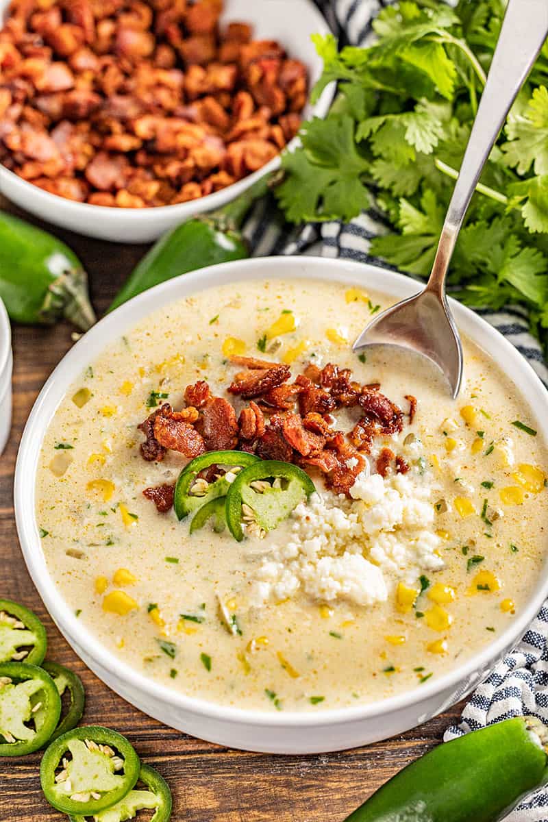 Street corn soup in a white bowl.