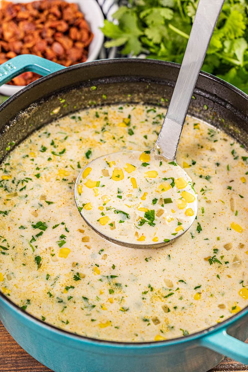 A stockpot filled with Mexican street corn soup.