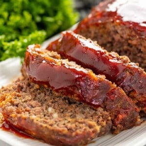 Meatloaf sliced on a white platter.