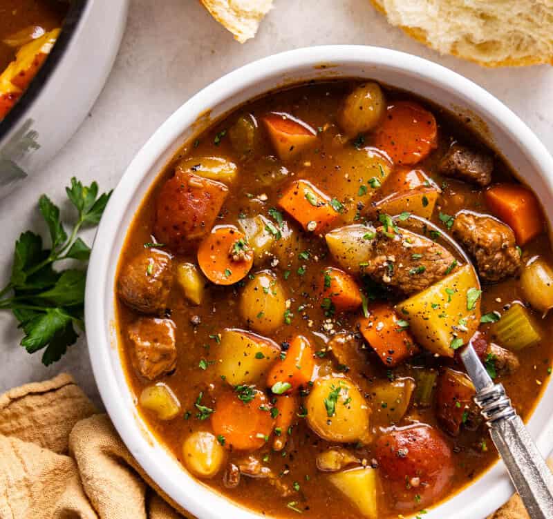 Overhead view of beef stew in a white bowl.