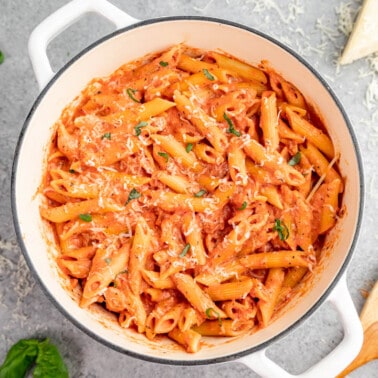 Overhead view of penne alla vodka in a white stockpot.