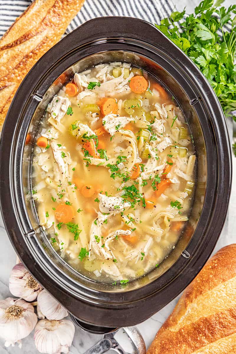 Chicken noodle soup in a slow cooker.