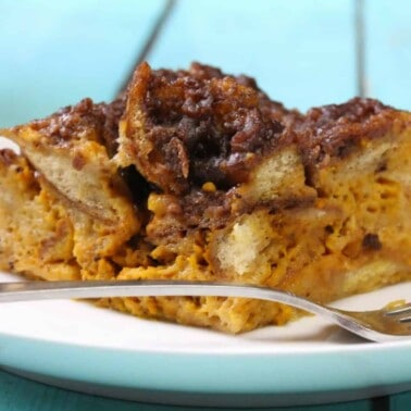 Slow Cooker Pumpkin French Toast on a white plate with a fork.