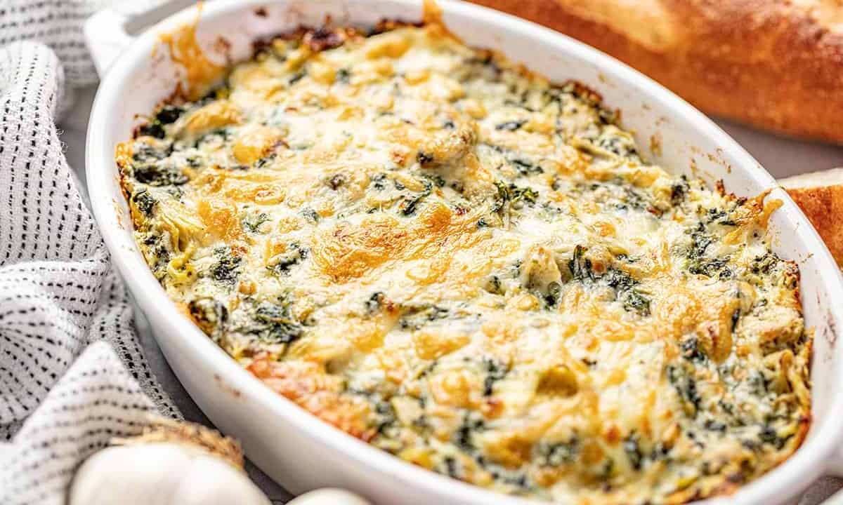 Spinach artichoke dip in white baking dish