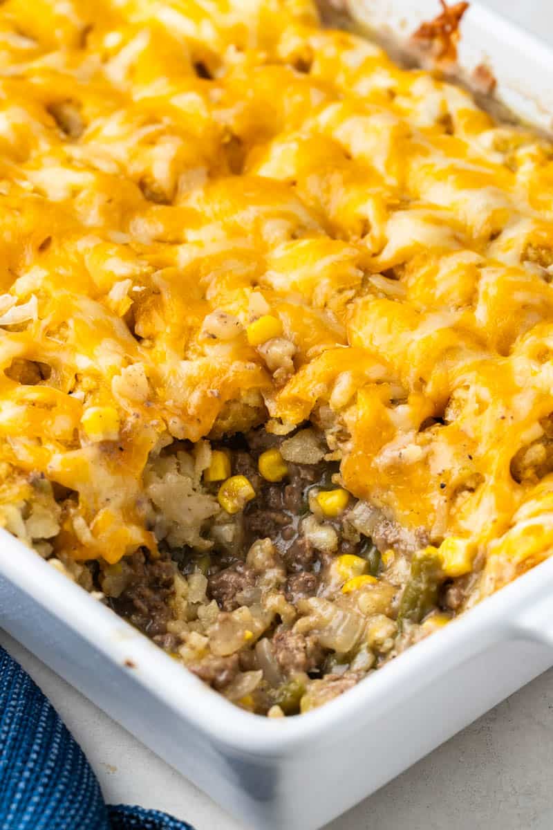 Tater tot casserole in a white baking dish.