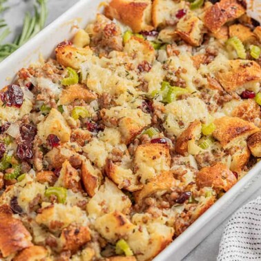 Angled view of Sausage Stuffing in a white serving dish.