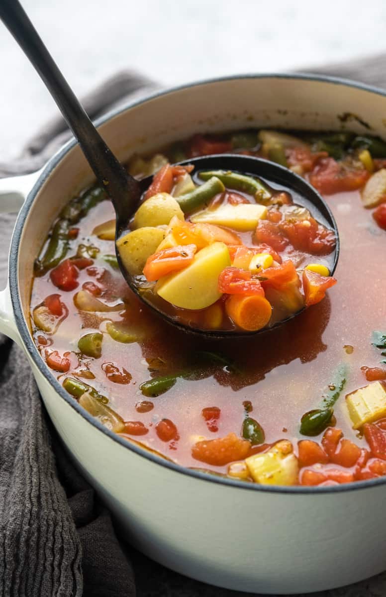 A ladleful of vegetable soup.