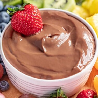 A ramekin filled with nutella fruit dip.